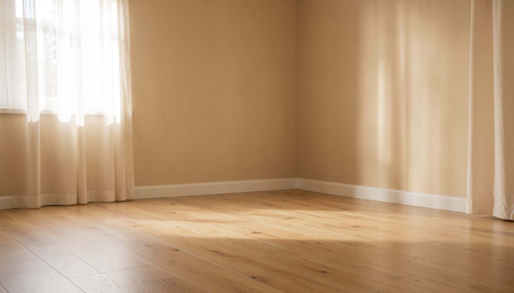 A calm, softly lit yoga space with warm beige walls, a wooden floor, and gentle natural light filtering through sheer curtains
